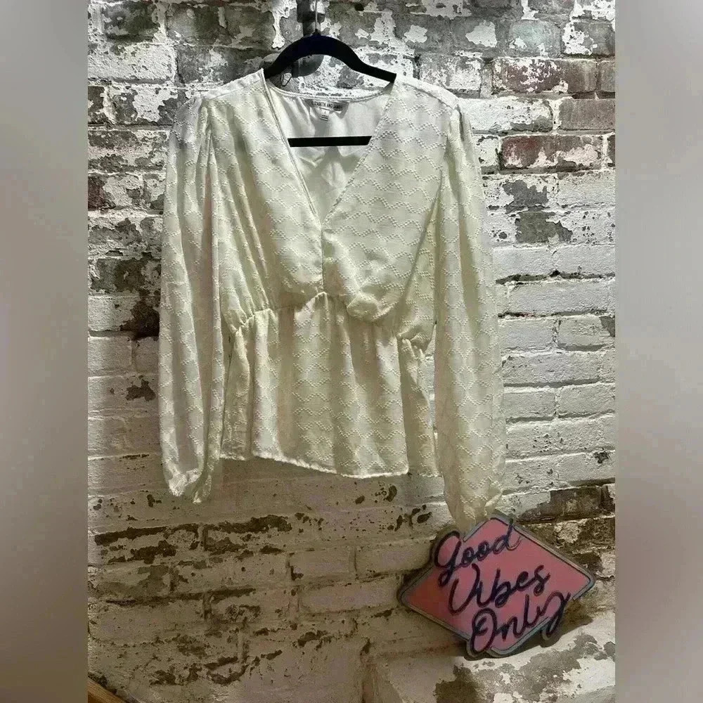 Elizabeth and James long sleeves, v neck peplum blouse in cream. Size Small.
